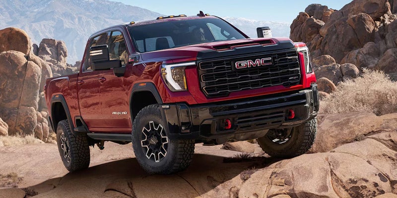 GMC Sierra HD in Volcanic Red Driving in the mountain